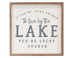 Lake-themed framed wall hanging artwork&nbsp;
*Made to order*

This unique piece is a simple way to bring beauty and charm to any wall within the home. It is made from high quality American hardwood planks with a hand painted face, and printed with UV cured ink, and is framed in a natural walnut frame. Each piece is unique with its own personality, marks, wood grain, and look.

Materials:
Wood

Dimensions:
16" wide x 1 1/2" deep x 16" high