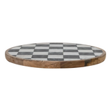 Round wooden cutting board with a checkered pattern on a white background