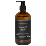 Amber bottle with pump and 'midnight amber' label on a white background