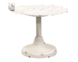 This ornate painted metal bird bath features a distressed white finish. It has a pedestal base, sunflower design, and a bird accent along the edge. It looks great displayed as is on a covered porch or embellished with florals and greenery. <br>