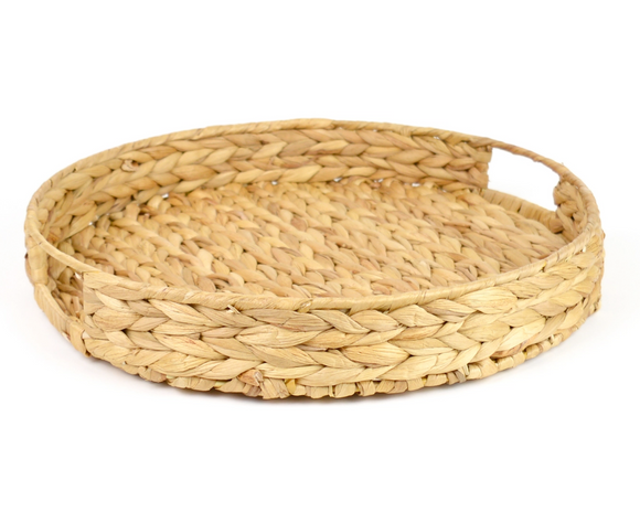 Natural water hyacinth woven round tray

With this natural woven round tray, your everyday dinner table setting is instantly transformed into an elegant one. Made of natural water hyacinth, this round tray boasts a timeless basket-weave design, making it perfect for both indoor and outdoor use. This exquisite piece features a tight weave and sturdy construction, while the convenient cut out handles make it easy to use, allowing you to effortlessly elevate your dinner service.