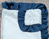 Luxurious navy blue &amp; silvery gray ribbon blanket
*Made to order*

Made from high-quality Minky fabrics, which comprise luxuriously soft microfibers, this navy blue and pale gray baby blanket features a matching satin ruffle trim. It is the perfect size for nap time cuddles. This blanket would be a great choice for a baby shower gift.

This item is proudly made in the USA.
