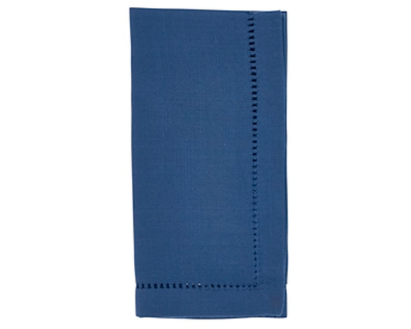 Folded blue napkin with decorative hem on a white background