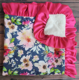 Floral fabric with pink ruffled edge on a wooden surface