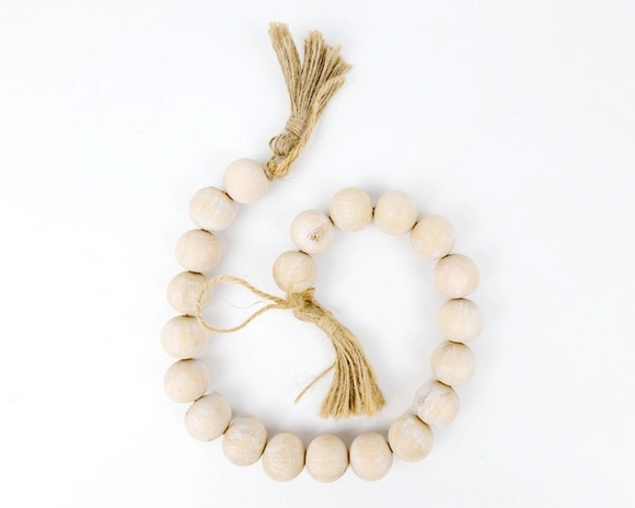 Wooden bead bracelet with a tassel on a white background