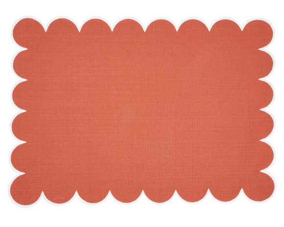 Orange placemat with scalloped edge on a white background