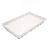Rectangular ceramic plate with a textured rim on a white background