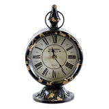 This farmhouse style table clock features a heavily distressed black and tan finish with a pedestal base. At just shy of 1 foot tall, this clock is the perfect size for an entryway table or coffee table.&nbsp;

Materials:
Metal, resin, plastic

Dimensions:
7" wide x 5" deep x 11" tall