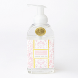 Foaming hand soap bottle with decorative label on a white background