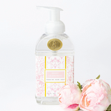 Foaming hand soap bottle with floral design and pink roses on a white background