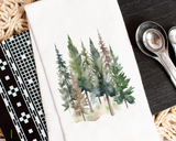 Notebook with a forest illustration on a textured surface with measuring spoons.