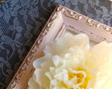 corner of pink ornate wooden picture frame inspired by shabby farmhouse chic antiques