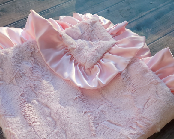 Luxurious baby pink blanket
*Made to order*

Made from high-quality Minky fabrics, which comprise luxuriously soft microfibers, this pink baby blanket features a matching satin ruffle trim. It is the perfect size for nap time cuddles. This blanket would be a great choice for a baby shower gift.

This item is proudly made in the USA.

Materials:
Minky fabrics

Dimensions:
30