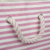Close-up of a pink and white striped bag with rope handles on a matching background.