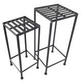 Two black metal bar stools on a white background