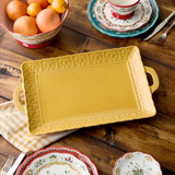 Make a stunning statement at your next gathering with the Provence Embossed Rectangular Platter, crafted in durable stoneware and featuring molded handles for easy carrying. At 17 inches long and 12.5 inches wide, this platter is perfect for showcasing everything from a roast to a rainbow of grilled vegetables or a vibrant charcuterie arrangement. Its embossed floral border and rich golden hue evoke the texture and elegance of hand-thrown pottery, adding timeless beauty to every occasion. The raised edges a