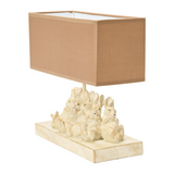 Distressed rabbit table lamp with shade

Set a relaxing tone in your home with this group of sleeping bunnies. The light from the lamp spotlights how precious and content these little friends are and passes that feeling on to you. The base has a white washed finish. Let these sleepy friends be the light in your room.

Materials:
Resin, linen fabric

Dimensions:
13" high x 5 1/2" wide x 14" long