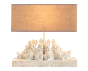 Distressed rabbit table lamp with shade

Set a relaxing tone in your home with this group of sleeping bunnies. The light from the lamp spotlights how precious and content these little friends are and passes that feeling on to you. The base has a white washed finish. Let these sleepy friends be the light in your room.

Materials:
Resin, linen fabric

Dimensions:
13" high x 5 1/2" wide x 14" long