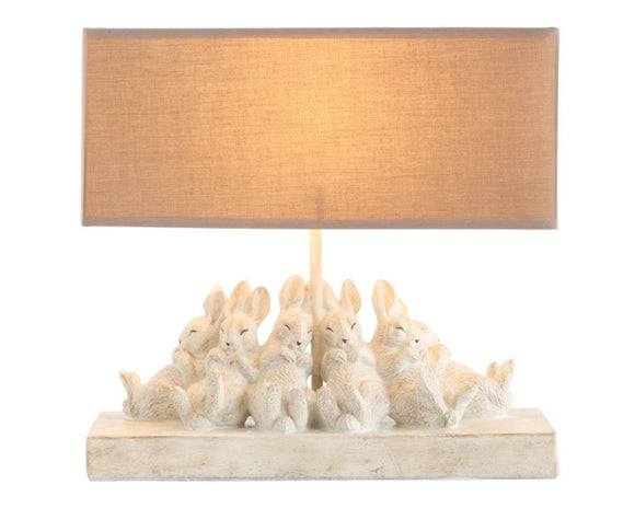 Distressed rabbit table lamp with shade

Set a relaxing tone in your home with this group of sleeping bunnies. The light from the lamp spotlights how precious and content these little friends are and passes that feeling on to you. The base has a white washed finish. Let these sleepy friends be the light in your room.

Materials:
Resin, linen fabric

Dimensions:
13