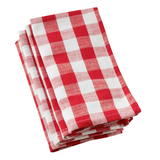 Stack of red and white checkered napkins on a white background