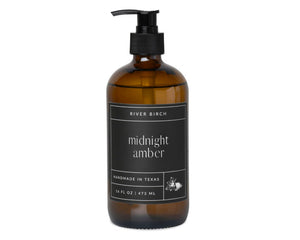 Amber bottle with black pump and label on a white background