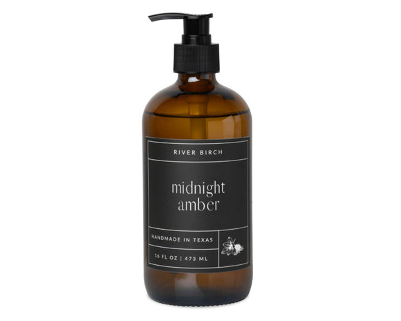 Amber bottle with black pump and label on a white background