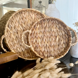 Woven basket with handles on a surface with decorative elements