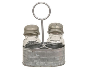Galvanized metal salt &amp; shaker set caddy

This caddy is a vintage-inspired piece made of galvanized silver metal with a raised pattern and a circular handle attached to the middle. Either side of the caddy holds a glass seasoning shaker with a screw-top metal lid with holes at the top. Fill these shakers with salt and pepper, and display this caddy on any tabletop, riser, or other kitchen surface for easy access with a decorative, farmhouse-inspired touch.

Materials:
Metal, glass

Dimensions:
4 1/4" wi