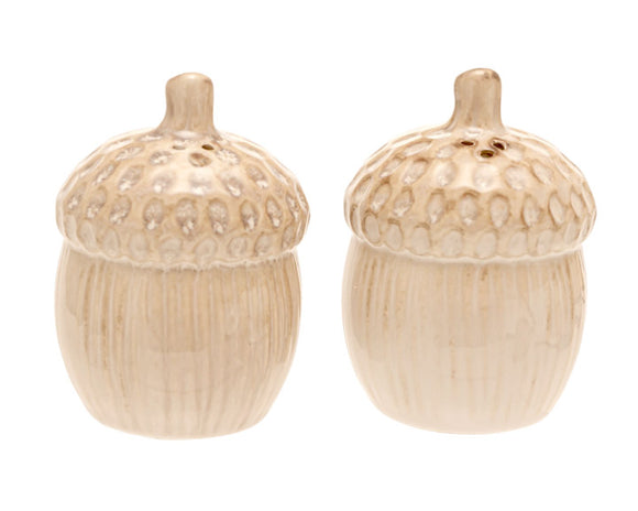 Two beige acorn-shaped ceramic salt and pepper shakers on a white background