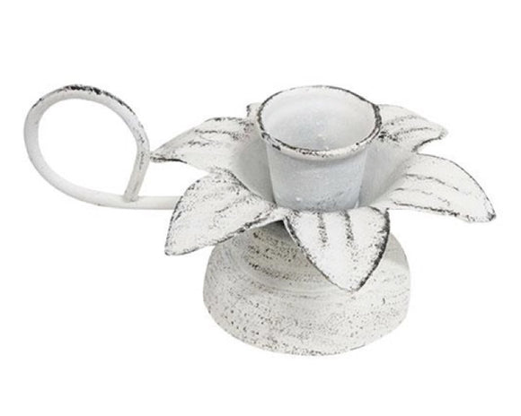 This small metal taper candle holder features a brushed white antique finish. The holder has a flower design with petals blooming out of the middle and contains a curved handle attached to the side of the piece. This is a great piece for spring or year-round use.<br>