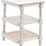 White side table with two shelves and woven cane design on a white background