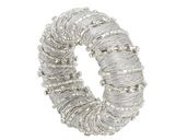 Decorative napkin ring with silver beaded design on a white background
