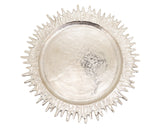 Decorative silver plate charger with a textured rim on a white background