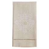 Textile with embroidered snowflake design on a plain background