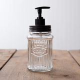 Clear glass soap dispenser with black pump

Function meets style with this soap dispenser. The jar reads, "Soap." It comes with a clear glass jar and black pump. Pair this with other black bathroom accessories to complete the look.

Materials:
Glass, metal, plastic

Dimensions:
3" diameter x 7 3/4" high