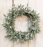 This wreath is made of artificial mistletoe leaves that have been flocked with glitter for a wintry character. The leaves are set on a natural grapevine base that is accented by white berries. This wreath is ideal for display on a front door or hung on a prominent wall.

Materials:
Silk, foam, plastic, wood

Dimensions:
22" diameter