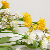 This candle ring is a decorative floral piece with a green-wrapped base. It is perfect to use as a candle ring around a larger pillar candle or as a miniature wreath. The ring as soft, foamy greenery and features cream and yellow astilbe buds alongside layered cream and yellow blooms. This ring brings a bright and cheerful touch to the home during the spring and seasons. They would also work well as wedding decorations.

Materials:
Foam, fabric, wire

Dimensions:
6 1/2" inside diameter&nbsp;
12" outside dia