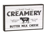 'Sweet Creek Creamery' wooden box sign

Our box sign offers a classic farmhouse look with black and white artwork in the style of an antique creamery advertising sign. This eye-catching piece features painted black side panels which frame the vintage influenced design. This sign makes for a great addition to your kitchen.

Materials:
Wood

Dimensions:
7 1/2" high x 1 1/2" deep x 11 3/4" wide
