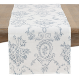 Decorative table runner with floral and paisley pattern on a wooden table.