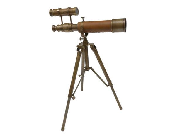 This tabletop antique brass telescope is a refractor-style telescope mounted on a brass tripod. It is a functional telescope with clear glass lenses. The telescope is focused by rotating the lens adjuster on the telescope barrel. The tripod legs are antique brass and adjustable with a screw release allowing this telescope to also level on uneven surfaces. There is an attached finderscope to aid in the location of the focal object. 