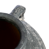 Close-up of a textured stone pot with a white background