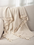 Neutral beige throw blanket with tassel detail