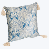 Decorative pillow with blue and beige floral pattern and tassels on a white background
