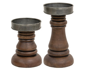 Walnut-stained wooden candle holders

These walnut-stained wood and metal candle holders look great with vintage farmhouse decor and are perfect holding our 3" diameter battery operated candles. The pair has a classic turned wood shape, while the mixed materials offer an on-trend appeal. These candle holders make for a great gift.

These candle holders hold up to a 3 1/4" diameter pillar candle.

Materials:
Wood, metal

Dimensions:
Shorter candle holder -
3 1/2" diameter x 5" high

Taller candle holder -
3 