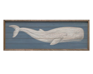 large neutral toned whale atop blue background framed in wood