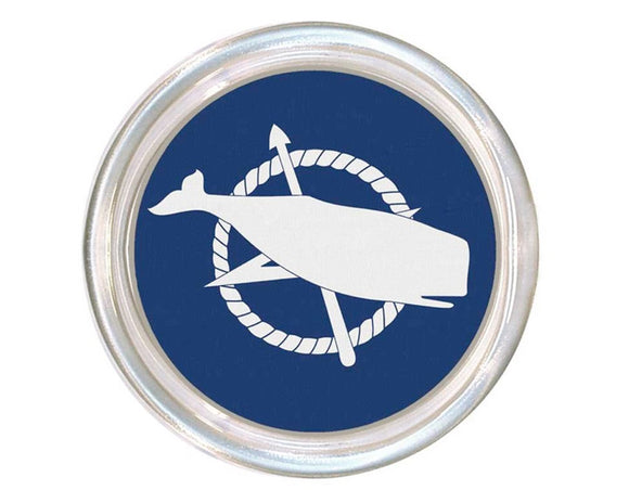 Round badge with a white whale and anchor design on a blue background