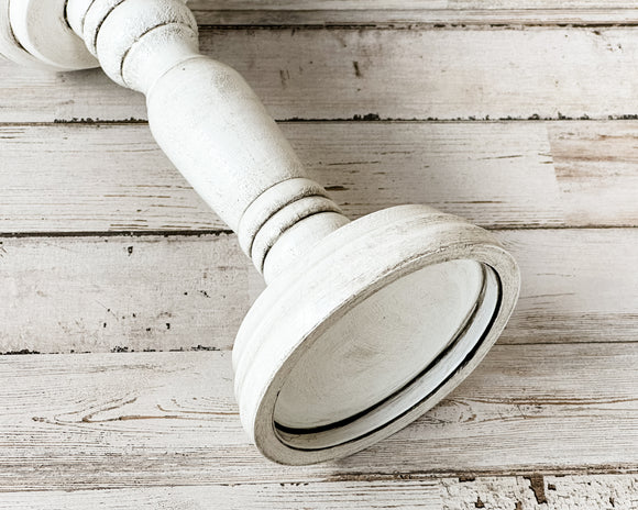 White & gray short pillar candle holder
*Made to order*

If you’re looking for farmhouse dining table decorations or shelf decor, look no further! These wooden candle holders complement almost any home or dining room decor. Place several of these candlesticks in a group on a dining room table for centerpiece or on a mantel in a living room for a vintage-inspired spring candlescape.

Sold individually, each candle holder is painted in white and accented with a hand-rubbed black antiquing glaze to bring o