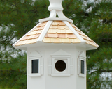 Handmade crisp white birdhouse with finial top

This large hexagonal wooden bird house features faux window shapes, a top finial to height, and a shingled roof. Made by hand in Ohio, it is painted in crisp white. This birdhouse can be displayed on its own or mounted on a post, which is not included with your purchase.

This item is proudly made in the USA.

Materials:
Wood

Dimensions:
12" diameter x 14" high