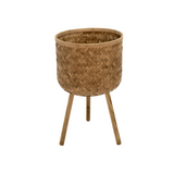 Woven basket with legs on a white background