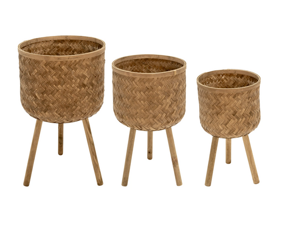 Three woven planters with wooden legs on a white background